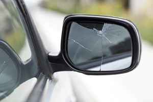A broken side mirror of a car that needs Car Window Repair in Macomb IL