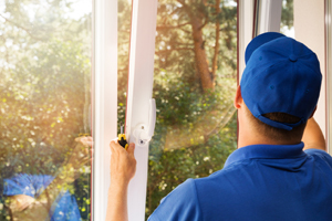 Worker performing Window Glass Repair in Geneseo IL by placing new glass in window frame