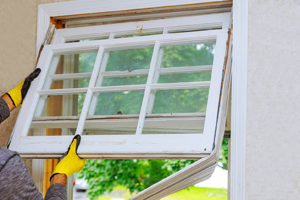 Worker taking out an old window during Window Repair in Kewanee IL