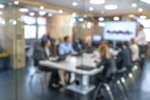 A company meeting happening in a conference room surrounded by Commercial Glass in Kewanee IL