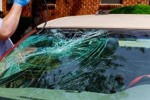 A cracked windshield is tended to after a car owner calls about Replacement Windows in Geneseo IL