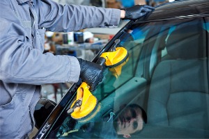 A team member of Glass Specialty WLC performs a Windshield Crack Repair in Macomb IL