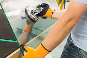 A team member of Glass Specialty WLC, a Window Company in Galesburg IL, works to replace a window.