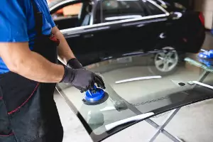 A team member of Glass Specialty WLC prepares to replace Auto Glass in Kewanee IL